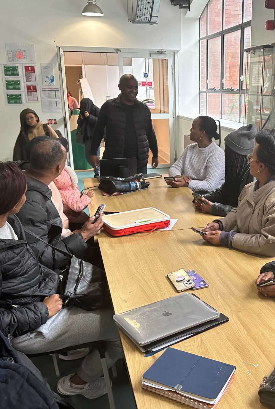 Ubuntu Pledge trainer leading a community group session around a large table